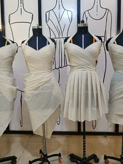 A lineup of mannequins showcasing different draped bodice styles created by students. This demonstrates the variety of international draping methods we teach.