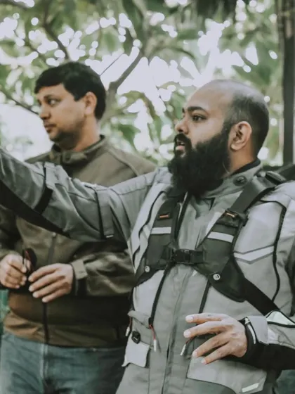 A candid shot of a rider giving directions or sharing a story with the group. It highlights the collaborative and communicative nature of these community rides.