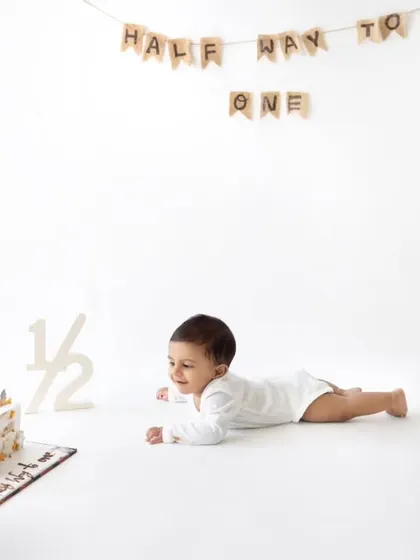 Crawling towards the cake! The minimalist "Half Way to One" setup is clean, simple, and puts all the focus on the baby.