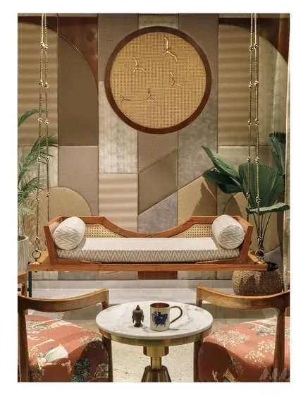 A straight-on shot capturing the symmetry and balance of the informal seating area. The traditional jhula is modernized with clean lines and paired with contemporary art and furniture.