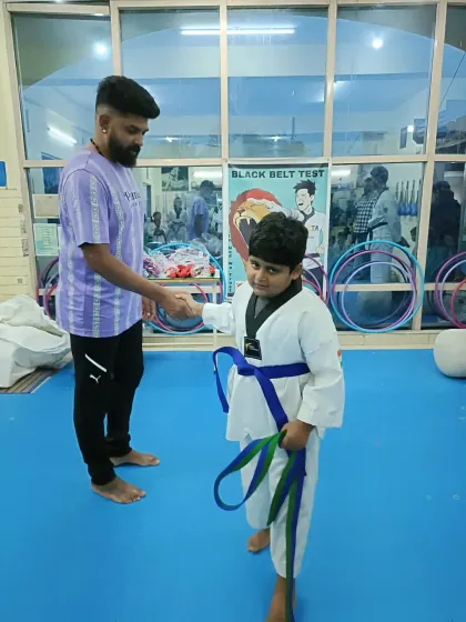A student receives his new belt.