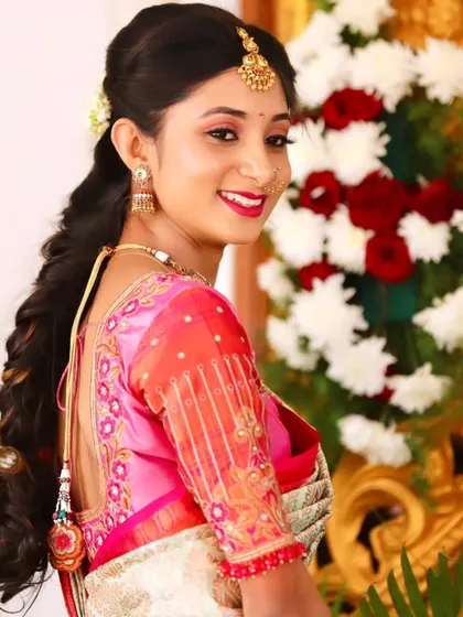 A happy, over-the-shoulder smile. This hairstyle with a simple braid and a pop of colour in the blouse is perfect for an engagement or mehendi.