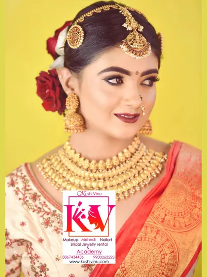 A smiling bride looking radiant. Her look features a classic winged eyeliner, a warm lip color, and a beautiful hair arrangement with red roses and traditional hair ornaments.