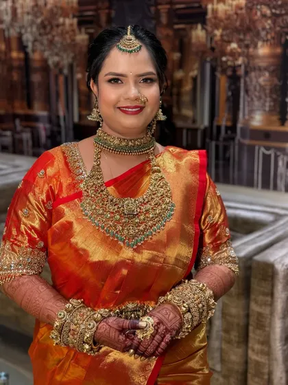 A real bride in a red and gold Kanjeevaram, her makeup soft and natural to enhance her features.