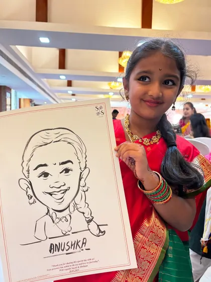 The pure delight on a child's face is priceless. Here's a young guest proudly showing off her black and white ink caricature, a fun party favor she can cherish.