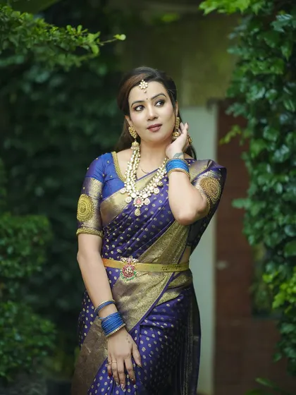 These photos capture a serene and elegant look, with the model wearing our Guttapusalu necklace set with a deep blue silk saree.
