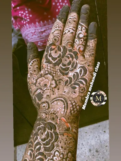 A close-up of a bridal palm, filled with dense, traditional patterns.