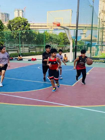 A young player drives to the basket with determination.