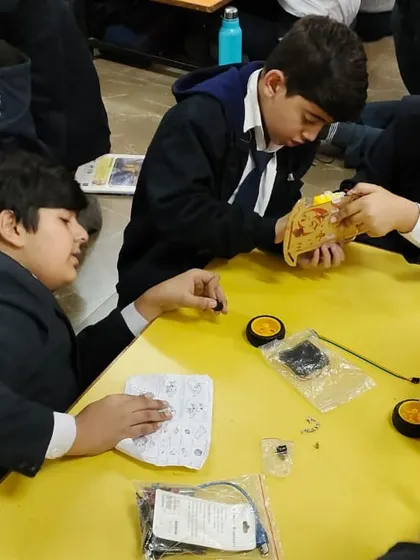 Students at Lions Public School collaborate on their robotics project, demonstrating focus and teamwork.