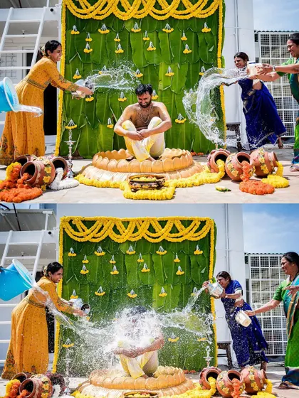 A fun, wide-angle shot of the Haldi ceremony, showing the groom being doused with water by his family against a vibrant, traditional backdrop.