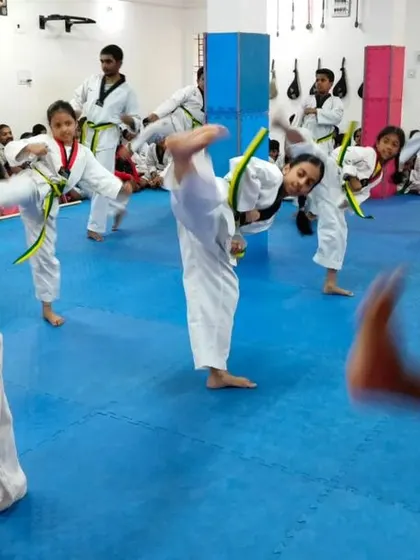 A student executes a high kick with great form.