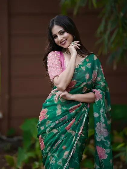 A smiling portrait in the green floral saree, a perfect look for a daytime event.
