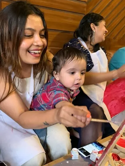 A mother and her baby enjoying a painting session together. We love creating a welcoming environment for families.