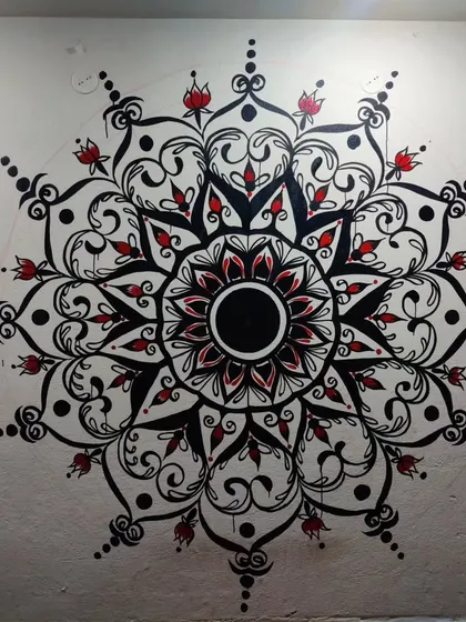 Adding pops of red to bring the mandala to life. This stage is where the personality of the piece really starts to shine through, highlighting specific elements within the complex geometric design.