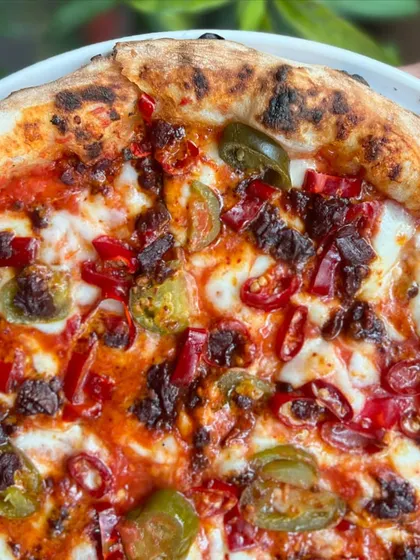 A close-up on the jalapeños and chili on our spicy pizza. For those who like it hot.