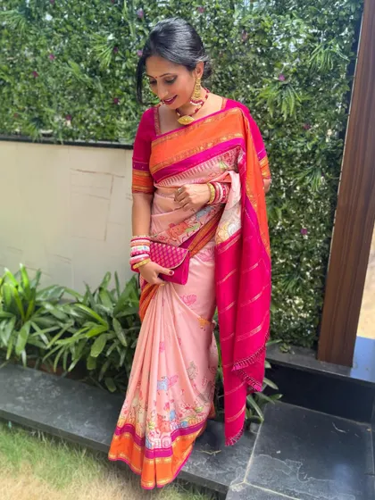 A full-length view of the client in her vibrant floral saree, a perfect outfit for a summer wedding or event.