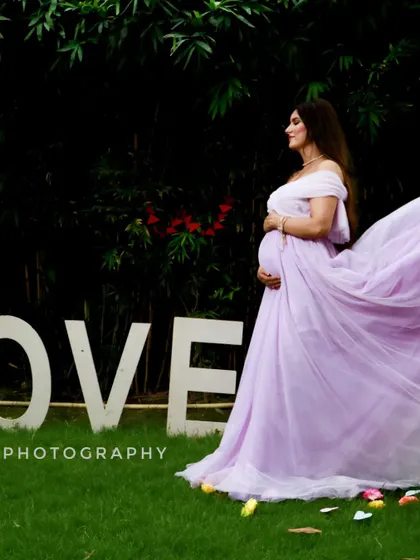 This lavender A-line gown looks stunning in motion. The lightweight fabric of the trail catches the air beautifully, adding a dynamic element to your maternity photos.