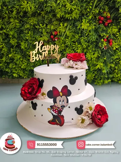 A two-tier Minnie Mouse cake with red roses and polka dots. This design combines classic elegance with the fun of a character theme.