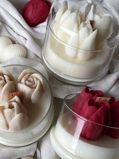 A different angle of the tulip jar candles, showcasing the red and beige options.