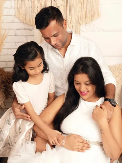 A quiet moment of love and anticipation. This family maternity photo captures the gentle connection as they all look toward the coming arrival.