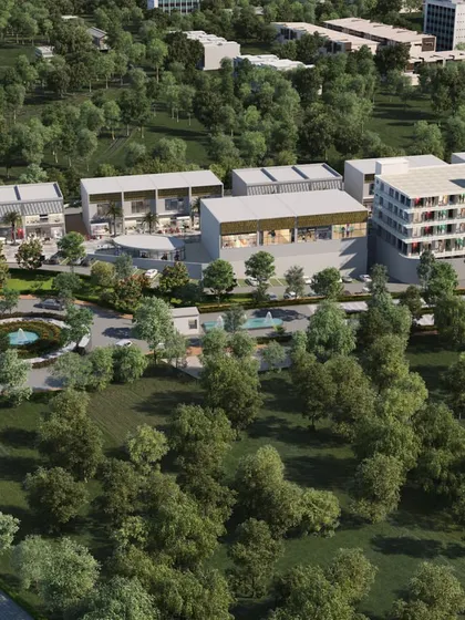 An aerial visualization of a mixed-use development adjacent to a major highway, showing its accessibility and integration with the surrounding natural landscape.