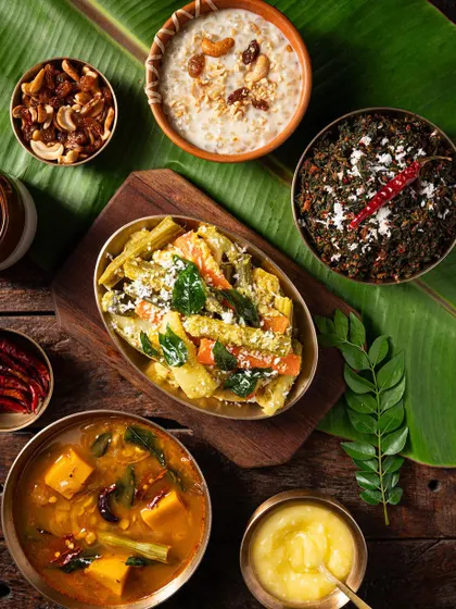 A flat lay of a South Indian meal on a banana leaf. This overhead perspective captures the beauty and arrangement of a traditional thali.