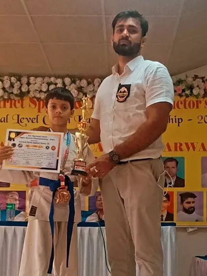 Standing with one of our blue belt national level winners at the Karwar championship. His hard work and discipline have brought him this success.
