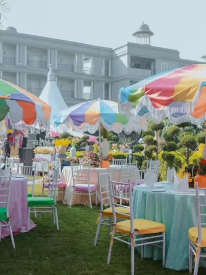 Guest seating at the 'Rang Rang Mein' Haldi, with multi-colored umbrellas and chair cushions creating a cheerful and festive atmosphere.