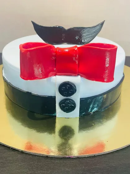 A fun and dapper cake for a dad or husband, designed to look like a shirt and bow tie with a mustache topper.