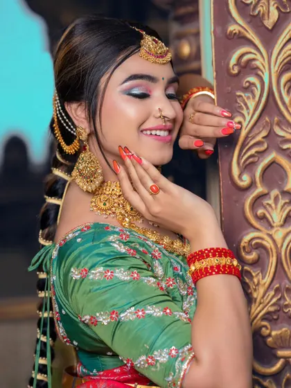 A side view that gives a great look at the traditional hairstyle with braid accessories, complementing the main jewellery set.
