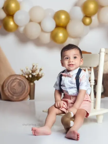This little one looks so dapper in his suspenders and bow tie, sitting patiently for his portrait.