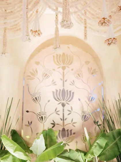 A close-up of the central lotus motif panel, flanked by lush banana leaves, creating a beautiful contrast between clean graphic design and organic nature.