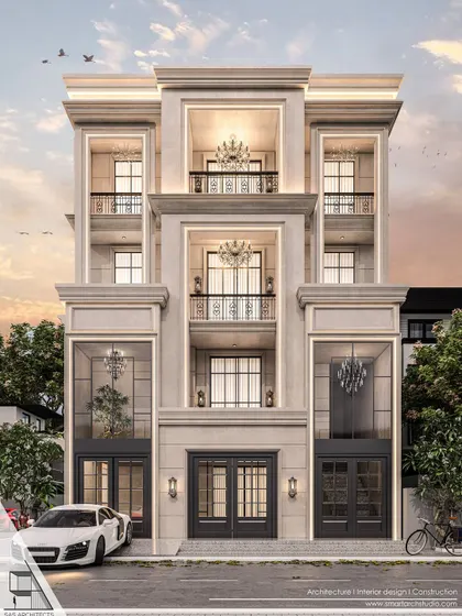 A design proposal for a residence in Vikaspuri. This symmetrical façade features grand chandeliers visible through large windows, ornate balcony railings, and classical moldings, all hallmarks of a luxurious neoclassical style.