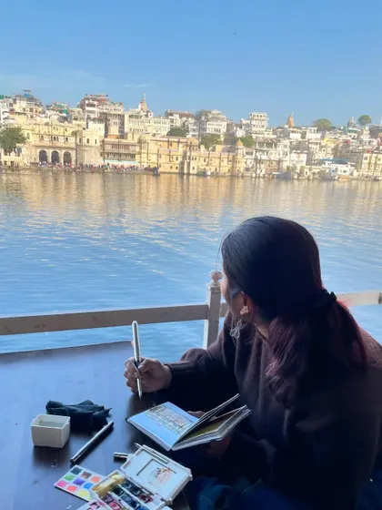Looking out over the lake in Udaipur, sketchbook in hand. This is the view that inspired my Gangaur Ghat painting.
