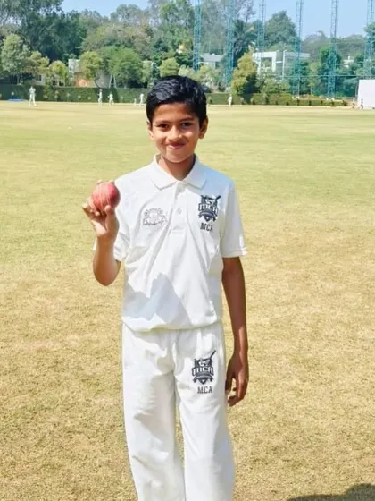 A young bowler from our academy proudly holds the ball after a great performance for Lions Cricket Club in the KSCA Under-12 league.