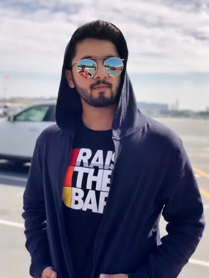 A cool, mysterious look in a hoodie and reflective sunglasses. It's all about the attitude.