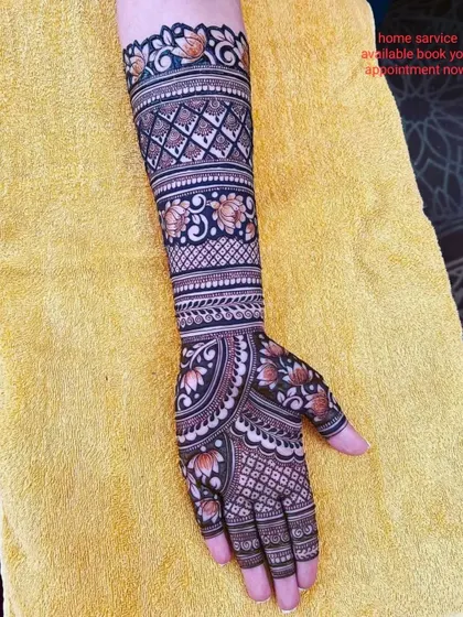 A beautiful design with lotus flowers and geometric patterns, showing the rich color of the henna.