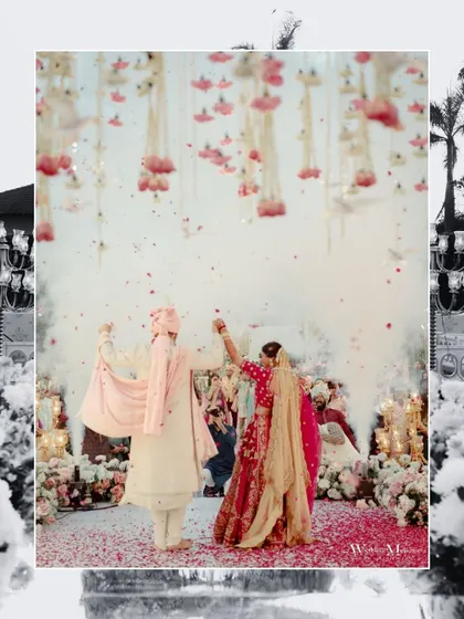 A magical shot of the couple during their wedding ceremony, with flower petals raining down around them. The back-lighting and celebratory atmosphere make this a truly dreamy photo.