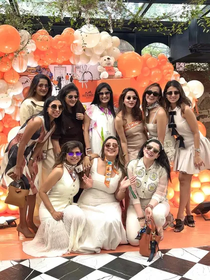The mom-to-be and her friends enjoying the chic, stylish atmosphere of the Hermès-themed shower.