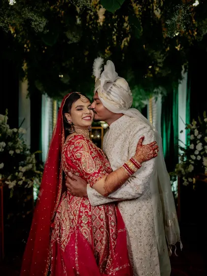 A regal bride in her magnificent red lehenga. We capture the grandeur of the bridal attire, creating portraits that are both powerful and elegant.