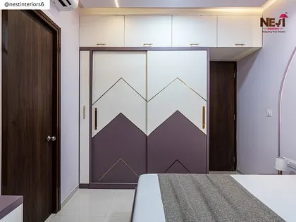The sliding wardrobe in this room is both a space-saver and a design statement. The two-tone design with gold inlay adds a touch of glamour and personality.