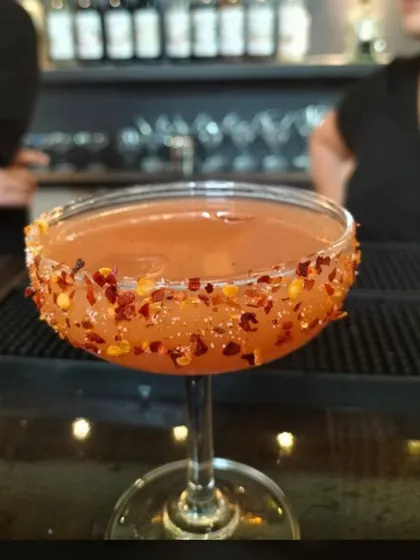 A close-up of our spicy chili-rimmed cocktail, a unique offering for guests with adventurous palates.