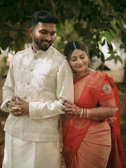 A sweet, comforting pose with the bride resting her head on the groom's shoulder, full of warmth and affection.