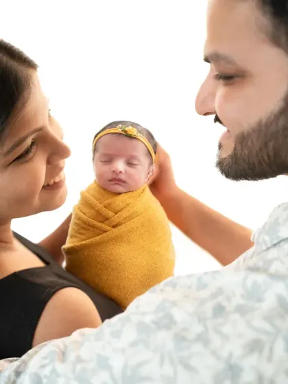 The look between new parents as they hold their baby is priceless. My lifestyle approach to family photos captures these candid, unscripted moments of connection.