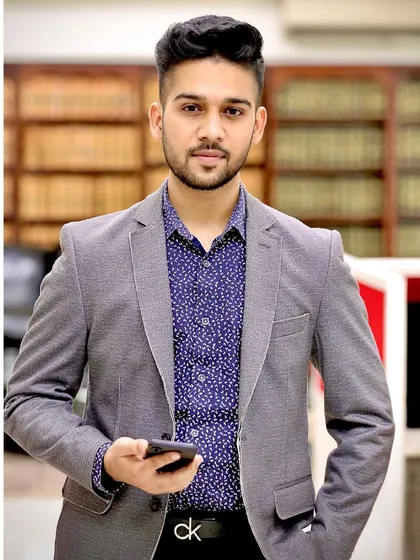 A professional headshot in my office, surrounded by law books. A good lawyer is one who wholeheartedly dedicates himself to the client's cause, and that is the standard I hold myself to.