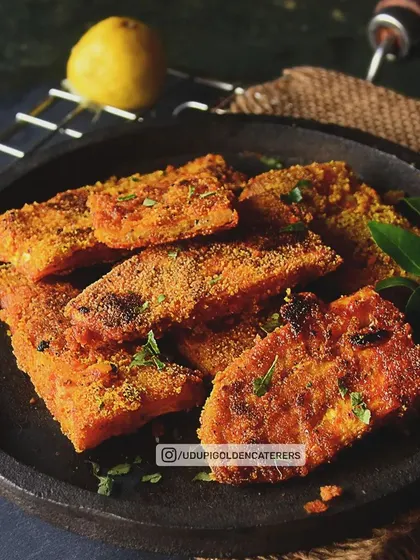 Slices of savory Rava Fry, a popular coastal Indian snack. We coat vegetables or paneer in a spiced semolina mixture and pan-fry them until crisp, offering a unique texture and taste.