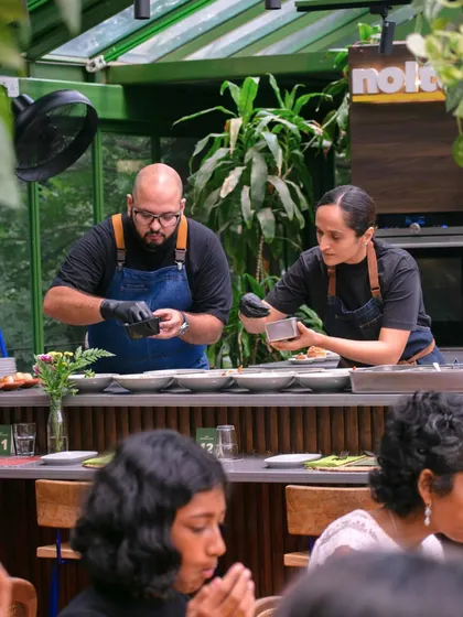 This is the focus and passion of my kitchen. Here, my co-chef Hanisha and I are plating dishes for a special event, ensuring every element is perfect before it reaches the table.