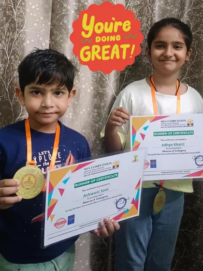 You're doing great! Our students Ashwani and Aditya from Katra Banda proudly display their runner-up certificates and medals.