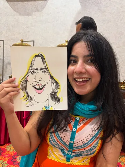 Her vibrant personality shines through in this picture, holding her equally lively caricature.