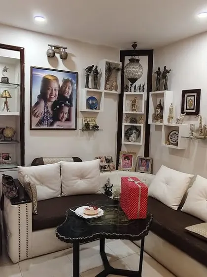 We love helping clients display their memories. This L-shaped seating arrangement is surrounded by custom shelves and display units, turning the living room into a gallery of their life's story.